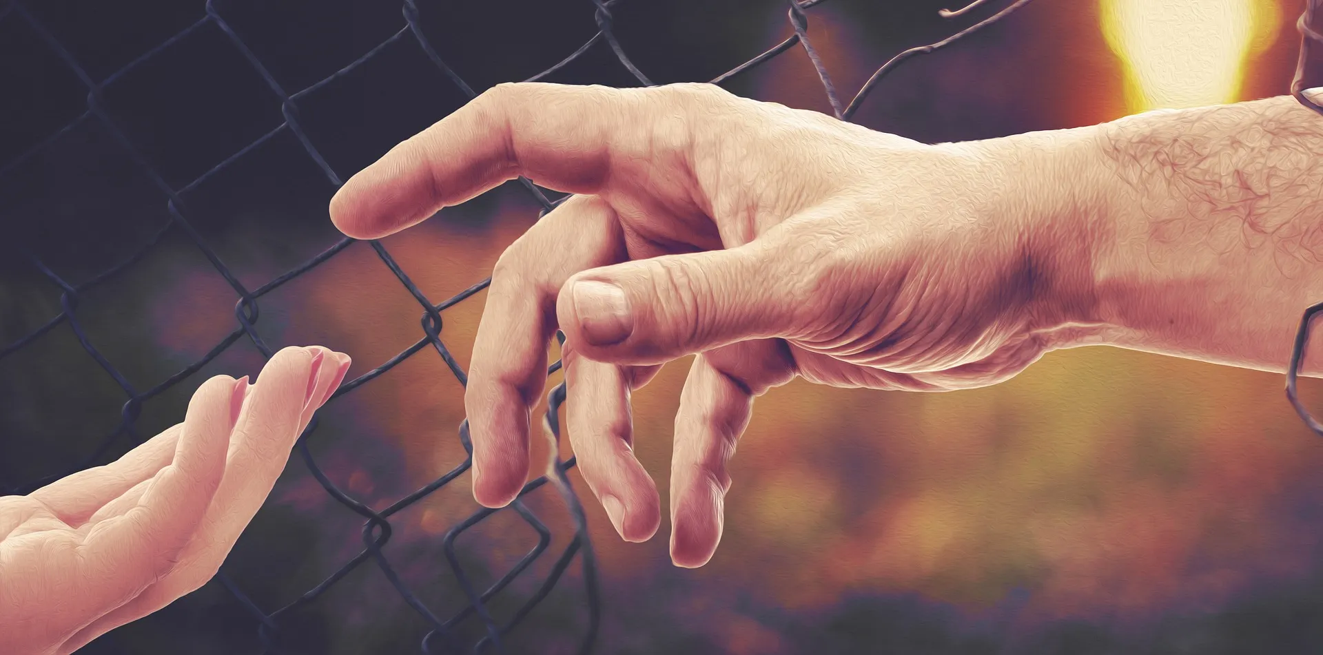 Two hands bring jigsaw puzzle pieces together.